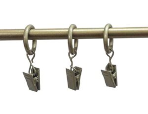 Three metal clips hanging on rod.