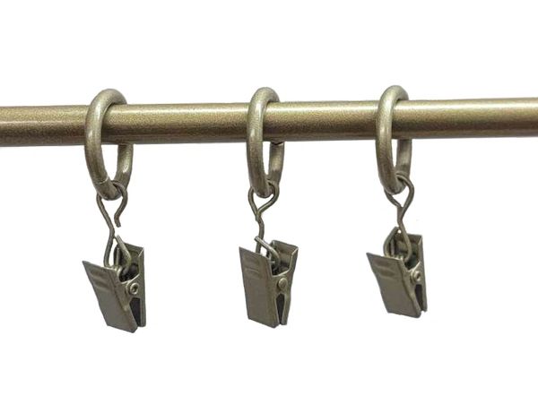 Three metal clips hanging on rod.